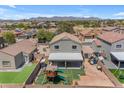 An aerial view showing backyard play area and mountain view in the distance at 23693 W Grove St, Buckeye, AZ 85326
