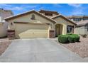 Beautifully landscaped single-story home featuring a neutral color palette and attached two-car garage at 23862 W Chambers St, Buckeye, AZ 85326