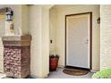 Welcoming front porch featuring brick accents, security door, and space for personalized decor at 23862 W Chambers St, Buckeye, AZ 85326