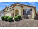 Well-maintained home with manicured bushes and decorative rock landscaping enhancing curb appeal at 23862 W Chambers St, Buckeye, AZ 85326