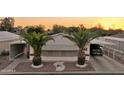 This home features palm trees, covered parking, desert landscaping, and an American flag at 2400 E Baseline Ave # 71, Apache Junction, AZ 85119