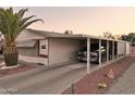 The home features covered parking, desert landscaping, and room for a truck at 2400 E Baseline Ave # 71, Apache Junction, AZ 85119