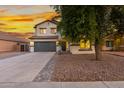 Two-story home featuring desert landscaping, a spacious driveway, and a convenient two-car garage at 2533 W Novak Way, Phoenix, AZ 85041