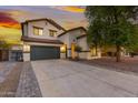 Inviting two-story home featuring desert landscaping, a spacious driveway, and a convenient two-car garage at 2533 W Novak Way, Phoenix, AZ 85041