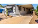 Charming mobile home with covered parking, desert landscaping, and a well-maintained exterior at 2650 W Union Hills Dr # 29, Phoenix, AZ 85027