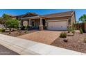Charming home with a well-manicured yard, neutral-toned exterior, and a paved driveway leading to a two-car garage at 29403 N 119Th Ln, Peoria, AZ 85383