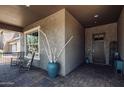 Inviting covered front porch with stylish décor and a cozy seating area near the front door at 29403 N 119Th Ln, Peoria, AZ 85383