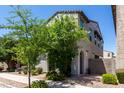 Charming two-story home featuring a textured facade, arched entryway, and well-maintained desert landscaping at 302 N 69Th Pl, Mesa, AZ 85207
