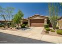 Well-maintained home featuring desert landscaping and a spacious driveway leading to the garage at 3336 W Morse Dr, Anthem, AZ 85086