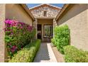 Inviting front entrance with stone accents, lush greenery, and a cozy seating area at 3336 W Morse Dr, Anthem, AZ 85086