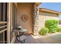 Cozy patio with stone columns, decorative sun art, and comfortable seating area at 3336 W Morse Dr, Anthem, AZ 85086