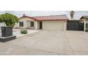 Traditional style home boasts a metal roof, charming white brick facade, and a long driveway at 4115 W Sierra St, Phoenix, AZ 85029