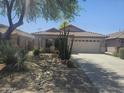 Charming single-story home with a tile roof and a well-maintained desert landscape at 4255 E Rock Dr, San Tan Valley, AZ 85143