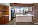 Functional kitchen with brick detailing, updated appliances, and ample counter space for cooking and entertaining at 501 E Alameda Dr, Tempe, AZ 85282