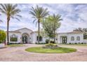Stunning white home with palm trees and circular driveway at 6443 E Malcomb Dr, Paradise Valley, AZ 85253