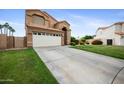 Charming two-story home with a well-maintained lawn and long driveway at 665 S Balboa --, Mesa, AZ 85206
