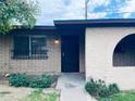 Charming home exterior featuring a secure iron gate, well-maintained garden, and a stone arch at 6729 N 16Th St # 21, Phoenix, AZ 85016