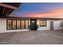 Charming home exterior with a modern black front door, decorative plants, and updated windows at 7026 E Pasadena Ave, Paradise Valley, AZ 85253