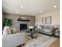 Bright living room featuring neutral décor, a cozy fireplace, and recessed lighting at 7026 E Pasadena Ave, Paradise Valley, AZ 85253