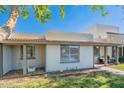 Attractive single-story house featuring a covered entrance, manicured lawn, and serene neighborhood surroundings at 8309 E Rose Ln, Scottsdale, AZ 85250