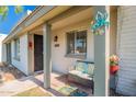 Cozy front porch area with seating, decorative accents, and a welcoming entrance to the home at 8309 E Rose Ln, Scottsdale, AZ 85250