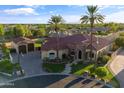Aerial shot of a beautiful home, showcasing its lush landscaping, red tile roof, and neighborhood at 8325 W Cantera Ave, Peoria, AZ 85383