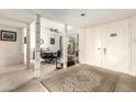 Inviting entryway featuring neutral carpet, decorative columns, and an arched doorway to a home office at 8540 N 43Rd Dr, Glendale, AZ 85302