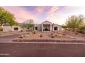 Beautiful modern home featuring desert landscaping and a welcoming circular driveway at 9301 E Via Montoya --, Scottsdale, AZ 85255