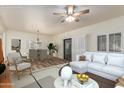 Inviting living room featuring hardwood floors, ceiling fan, and a modern white sofa at 9455 E Raintree Dr # 1025, Scottsdale, AZ 85260