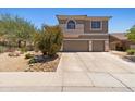 Two-story home featuring a tile roof, a two-car garage, and desert landscaping at 10415 E Rosemary Ln, Scottsdale, AZ 85255