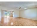 Living room with hardwood floors, neutral walls, ceiling fan and access to outdoor patio at 13631 N 103Rd Ave, Sun City, AZ 85351