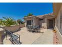 A spacious outdoor patio features a table and chairs perfect for entertaining guests at 16536 W Rock Springs Ln, Surprise, AZ 85374