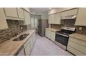 Well-equipped kitchen with modern appliances, stainless steel appliances, granite countertops and ample cabinet space at 17463 N Del Webb Blvd, Sun City, AZ 85373