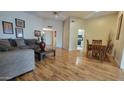 Spacious living room featuring hardwood floors, comfortable seating, and an open layout leading to the kitchen at 17463 N Del Webb Blvd, Sun City, AZ 85373