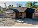 Cozy single-story home with a classic design, showcasing a private entrance and attached garage at 1914 W Colter St, Phoenix, AZ 85015