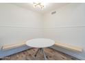 Charming breakfast nook area featuring an accent wall, a round table, and built-in bench seating at 1942 S Emerson -- # 211, Mesa, AZ 85210