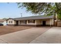 Street view of a single-story home featuring a convenient carport and long driveway at 2022 E Mulberry Dr, Phoenix, AZ 85016