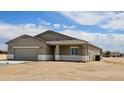 This move-in ready house has a garage and desert landscaping at 20427 W Mountain Sage Dr, Buckeye, AZ 85326
