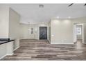 Spacious living room featuring wood-look floors, neutral walls, and a ceiling fan at 23408 W Barwick Dr, Wittmann, AZ 85361