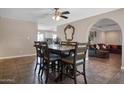 Open dining area features a stylish table adjacent to a cozy living room, promoting seamless entertaining at 2727 W Libby St, Phoenix, AZ 85053