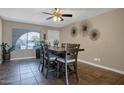 A charming dining area is illuminated by a modern ceiling fan and features an eye-catching wall decor at 2727 W Libby St, Phoenix, AZ 85053