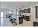 Bright, open kitchen with granite countertops, stainless steel appliances, and a central island at 30935 W Mulberry Dr, Buckeye, AZ 85396