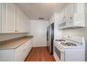 Bright kitchen features white cabinets, laminate countertops, and modern appliances at 3317 N 10Th Ave, Phoenix, AZ 85013