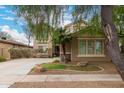 Charming home featuring a well-maintained lawn, desert landscaping, and a cozy two-story facade at 4254 S Winter Ln, Gilbert, AZ 85297