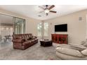 Spacious living room featuring neutral walls, plush carpet, and comfortable brown leather seating at 4254 S Winter Ln, Gilbert, AZ 85297