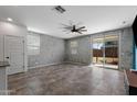 Spacious living area with tile flooring, a ceiling fan, and a sliding glass door to the backyard at 5429 W Chuck Box Rd, Laveen, AZ 85339