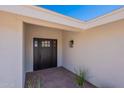 Close up view of the front door with a wall mounted lantern light fixture at 5525 E Waltann Ln, Scottsdale, AZ 85254