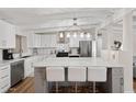 Modern kitchen featuring a large island with seating, stainless steel appliances, and white cabinetry at 5833 N 10Th St, Phoenix, AZ 85014