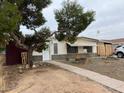 Modest single story home with mature shade tree in front yard at 639 S 92Nd Pl, Mesa, AZ 85208