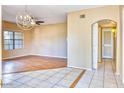 Open-concept living space with hardwood floors, large window, and tiled entryway with arched doorway at 6885 E Cochise Rd # 129, Paradise Valley, AZ 85253